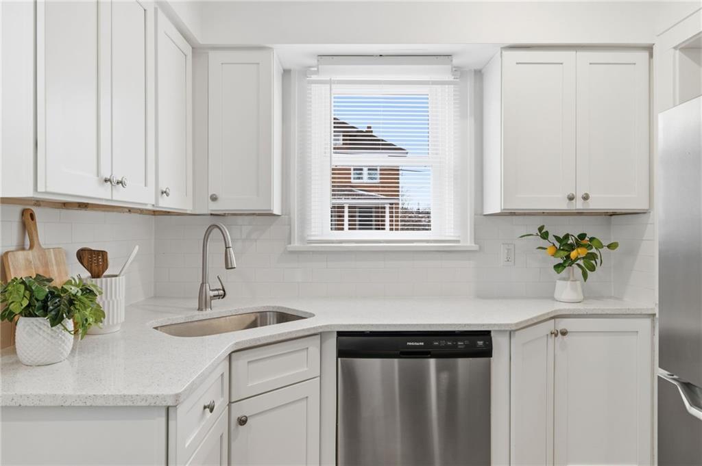 8 Esther Street Pittsburgh, PA 15227 - Photo 11 of 36 a kitchen with stainless steel appliances white cabinets and a window