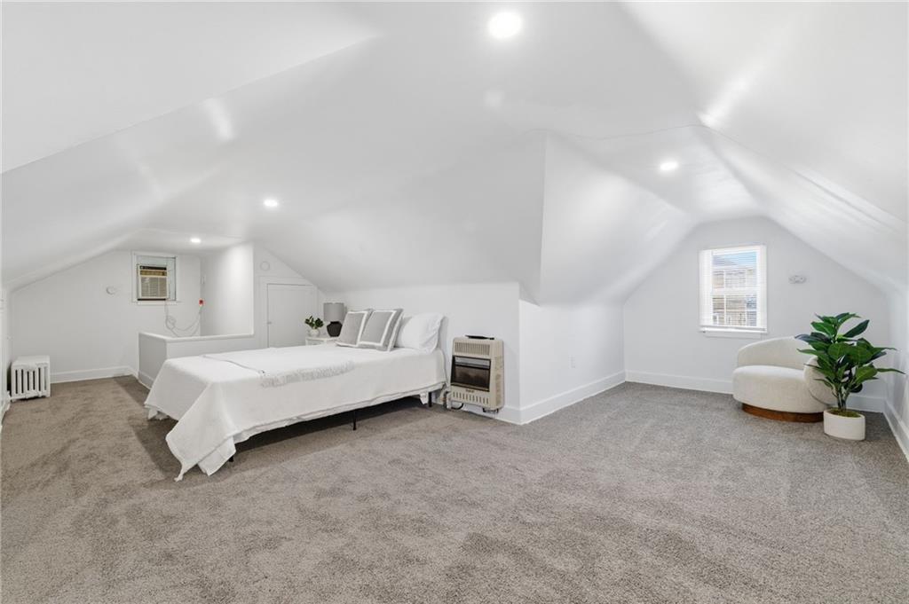 8 Esther Street Pittsburgh, PA 15227 - Photo 20 of 36 a spacious bedroom with a bed and a chandelier