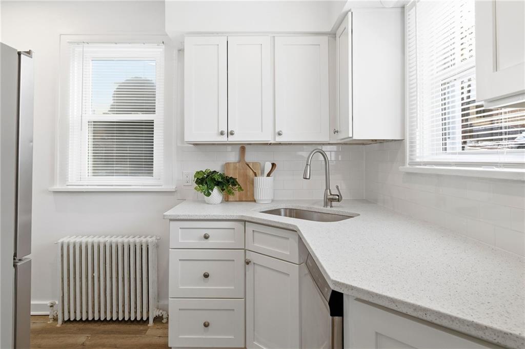 8 Esther Street Pittsburgh, PA 15227 - Photo 9 of 36 a kitchen with white cabinets and a window