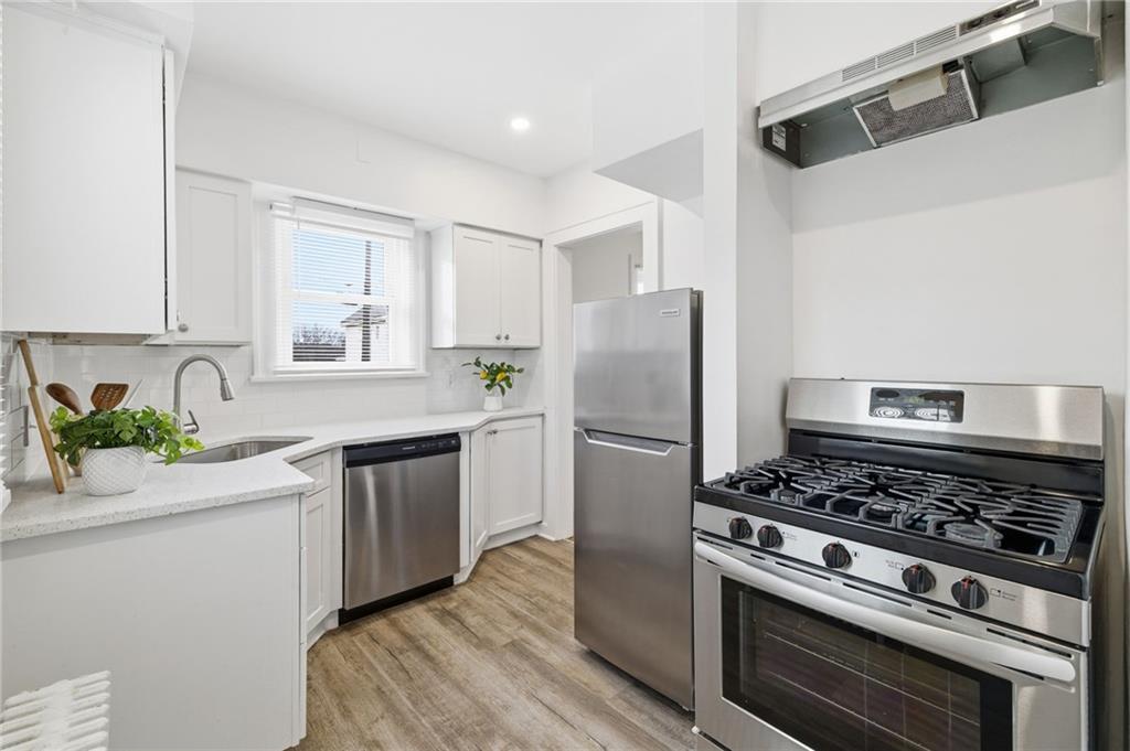 8 Esther Street Pittsburgh, PA 15227 - Photo 10 of 36 a kitchen with stainless steel appliances a stove a sink and a refrigerator
