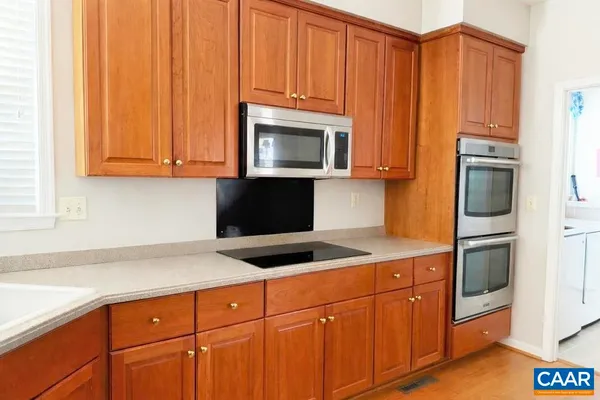 a kitchen with granite countertop cabinets stainless steel appliances and a sink