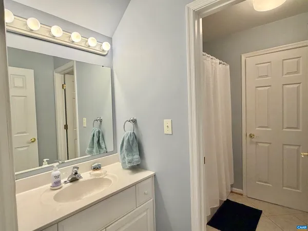 a bathroom with a sink vanity granite and a mirror