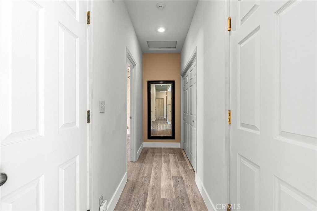 378 Picholine Way Chico, CA 95928 - Photo 17 of 52 a view of a hallway with wooden floor and a bathroom