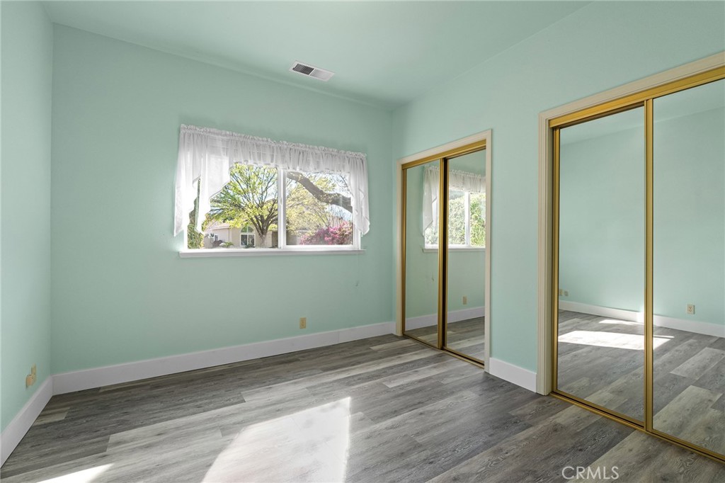 378 Picholine Way Chico, CA 95928 - Photo 19 of 52 a view of empty room with wooden floor and fan