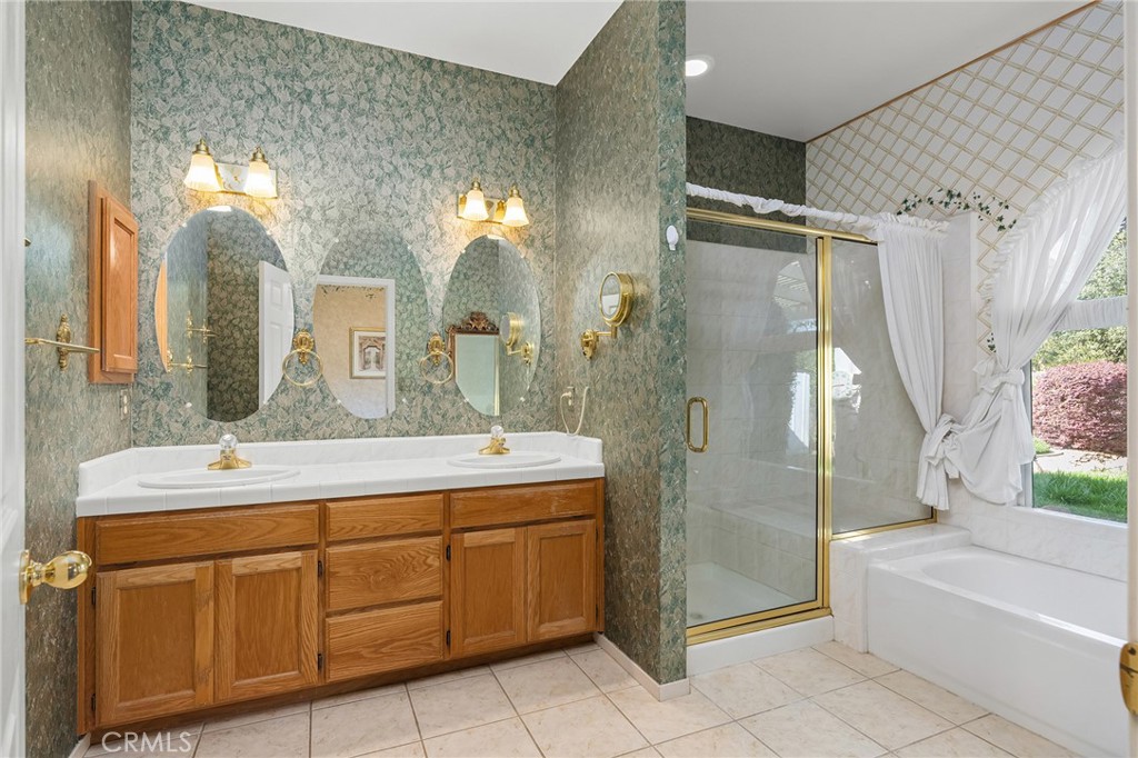 378 Picholine Way Chico, CA 95928 - Photo 30 of 52 a spacious bathroom with a double vanity sink toilet mirror and bathtub