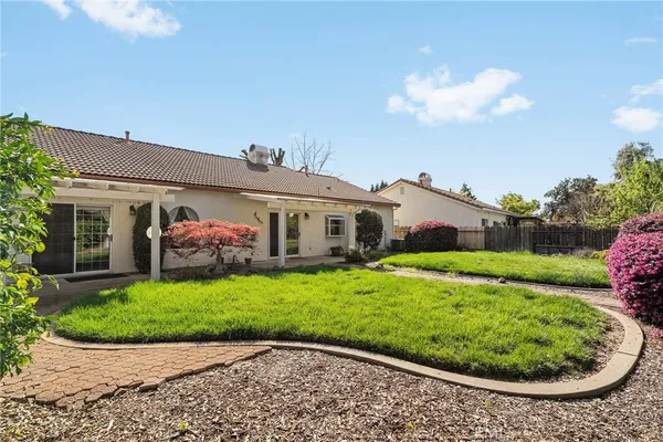 a yellow house with garden in front of it
