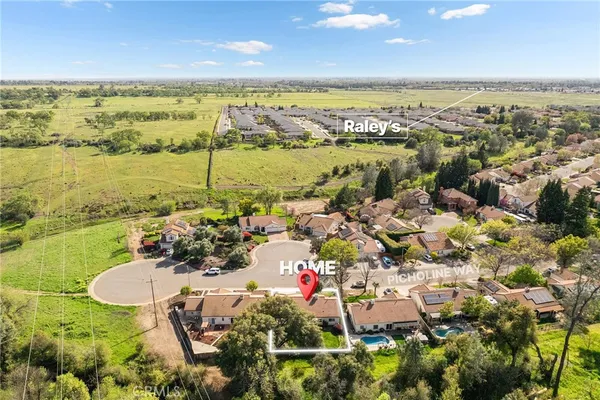 an aerial view of a house with a yard and lake view