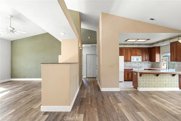 a view of a hallway with wooden floor