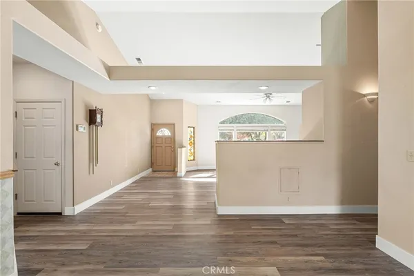 a kitchen with stainless steel appliances granite countertop a stove top oven a refrigerator a sink and dishwasher with wooden floor