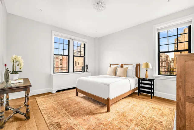 a spacious bedroom with a bed and a window