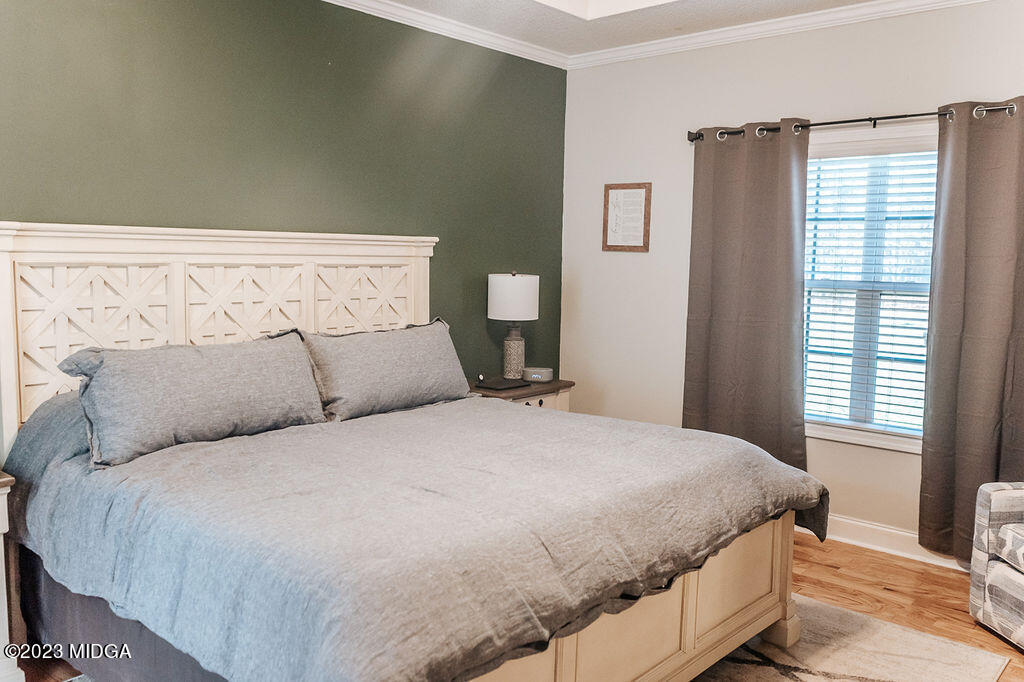 1068 Boulder Drive Gray, GA 31032 - Photo 17 of 34 a large bed sitting in a bedroom next to a window