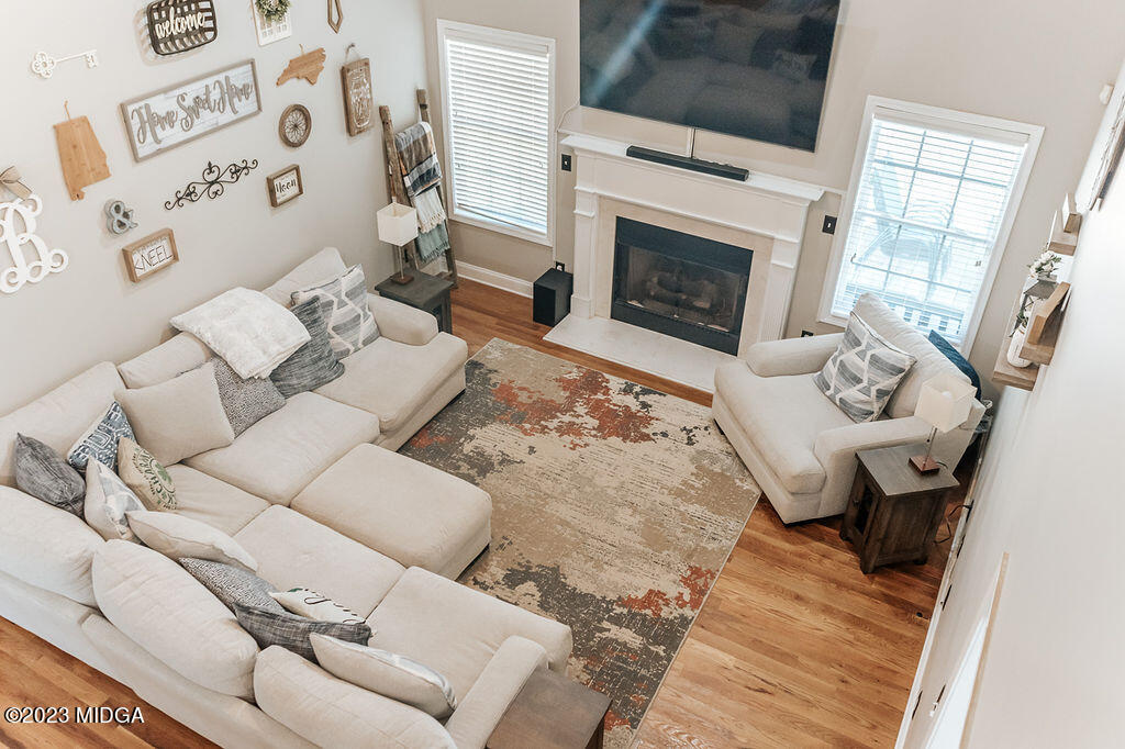 1068 Boulder Drive Gray, GA 31032 - Photo 8 of 34 a living room with furniture a flat screen tv and a fireplace