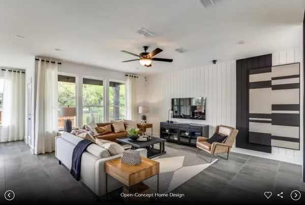 a kitchen with stainless steel appliances granite countertop a stove a refrigerator a sink a dining table and chairs with wooden floor