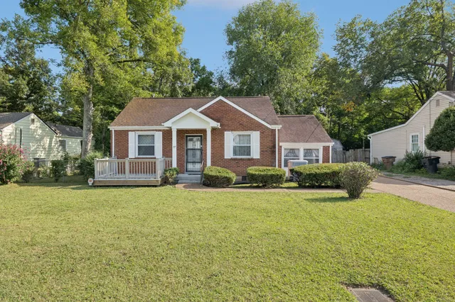 a front view of a house with a garden