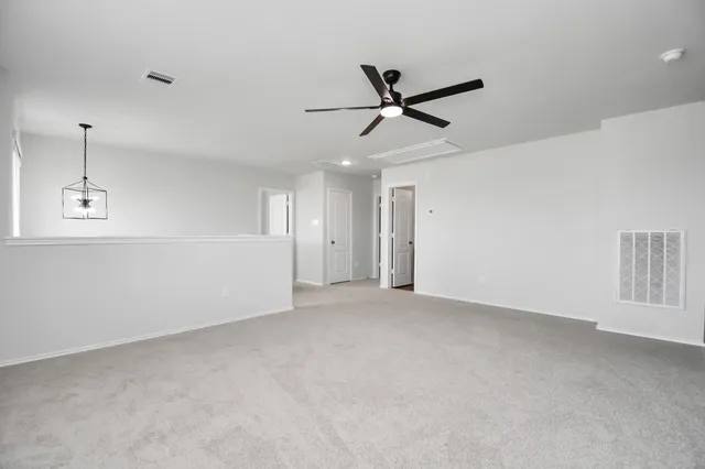 a view of a livingroom with a ceiling fan and window