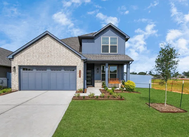 a front view of a house with a yard table and chairs