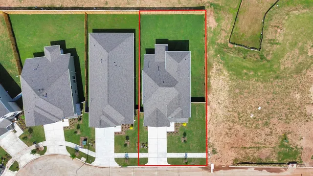an aerial view of a house with a backyard