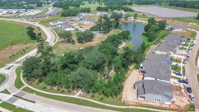 an aerial view of residential houses with outdoor space and street view