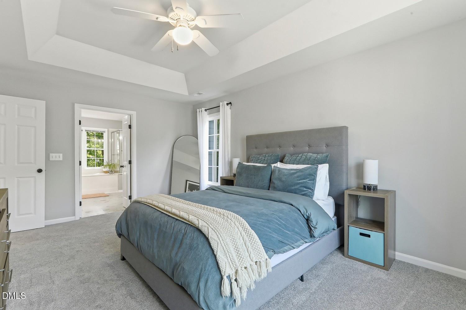 4001 Batiste Road Raleigh, NC 27613 - Photo 29 of 63 a bedroom with a bed and a chandelier
