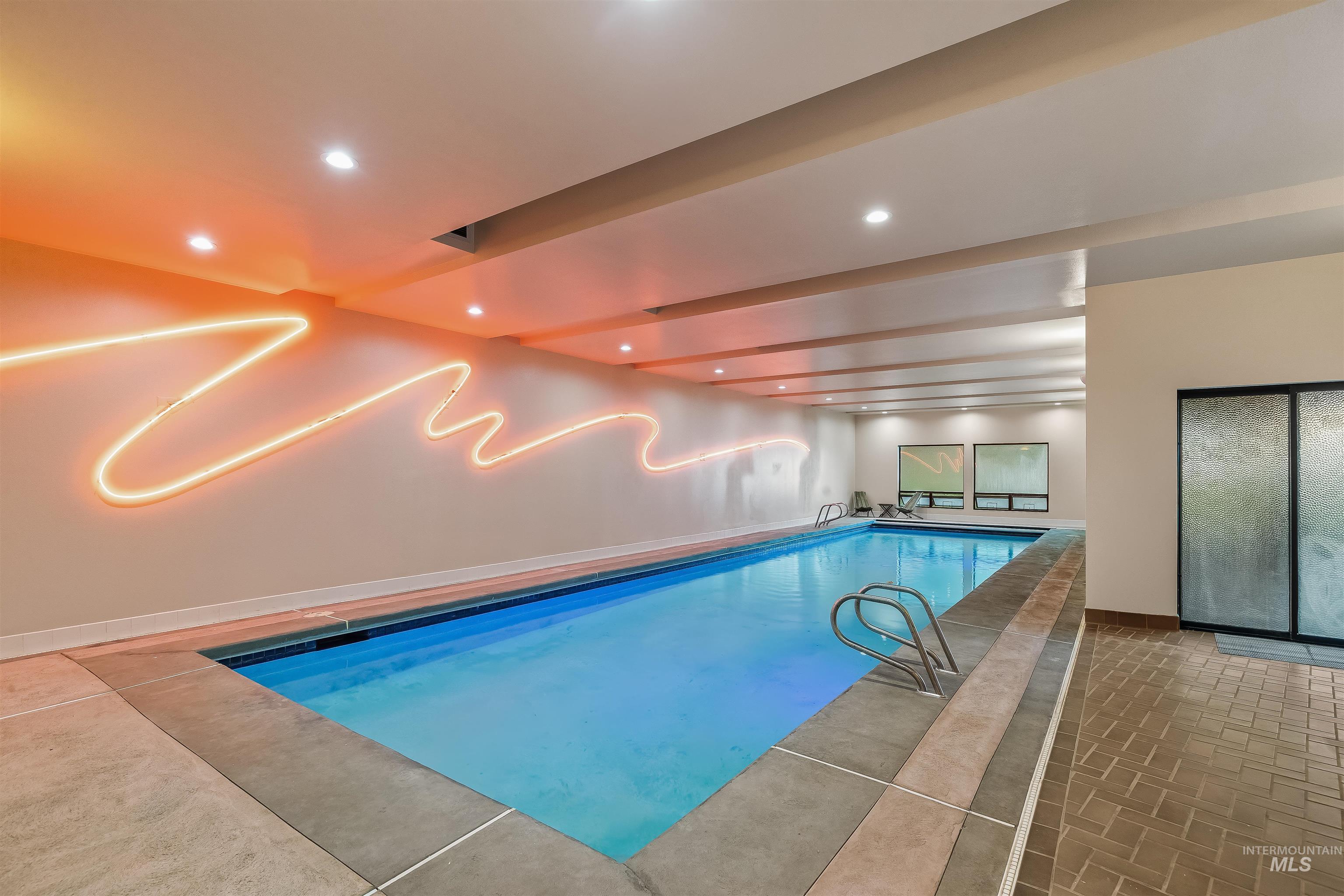 2048 Arborcrest Road Moscow, ID 83843 - Photo 14 of 50 Indoor swimming pool with integrated lighting, recessed ceiling lights, and textured wall art
