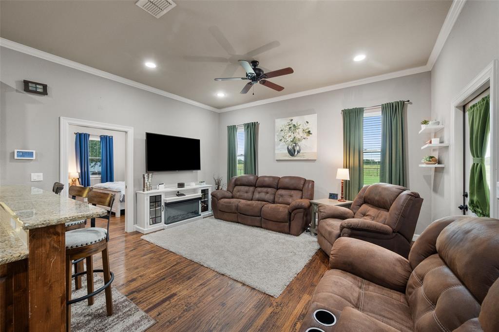 606 Sunset Point Kerens, TX 75144 - Photo 25 of 39 a living room with furniture and a flat screen tv