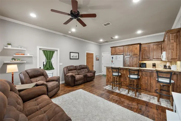 a living room with furniture and a wooden floor