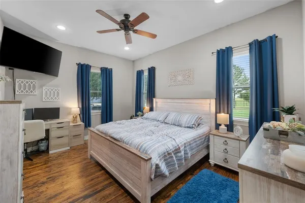 a bedroom with a bed and a flat screen tv