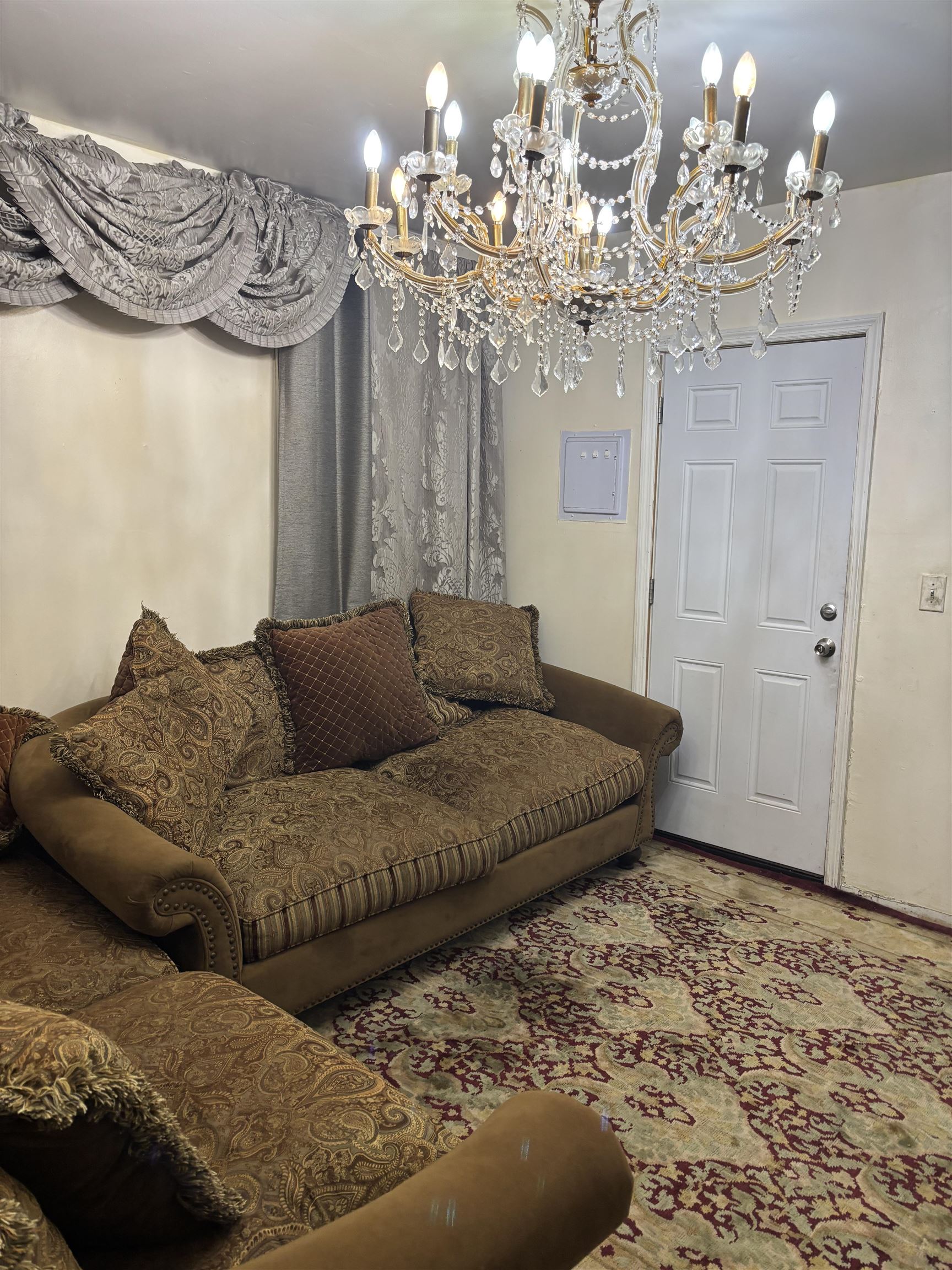 109 Centre Avenue, Unit FIRST Secaucus, NJ 07094 - Photo 10 of 19 a living room with furniture and a chandelier