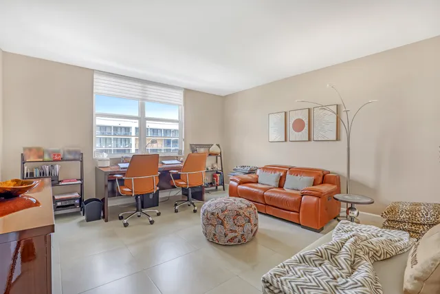 a bedroom with furniture and a flat screen tv