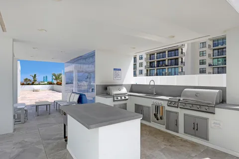 a dining room with stainless steel appliances kitchen island granite countertop a dining table and chairs