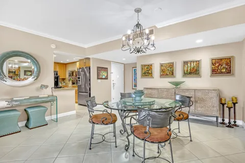 a view of a dining room with furniture and a chandelier