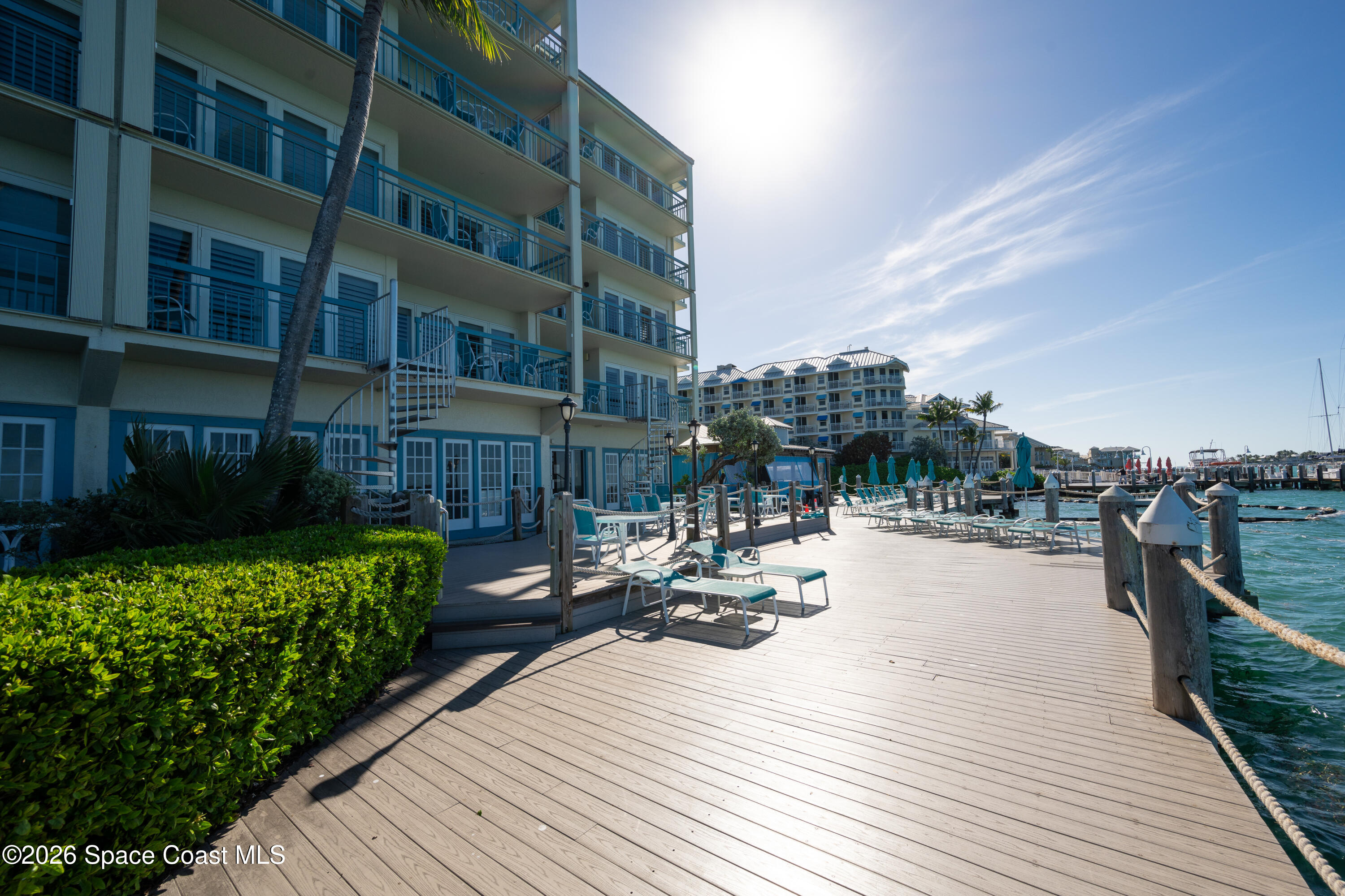 617 Front Street, Unit PHD54 Key West, FL 33040 - Photo 49 of 58 a view of a rooftop deck with chairs and tables on the wooden floor