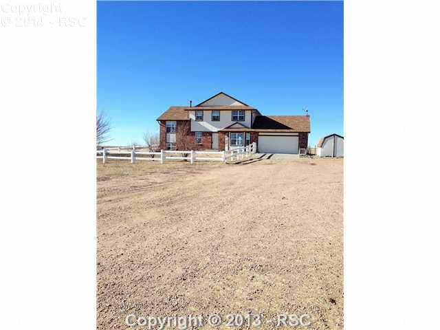 7950 Mulberry Road Calhan, CO 80808 - Photo 23 of 25 The house had a vinyl fence around the front yard and an oversize two car garage with a work shop.