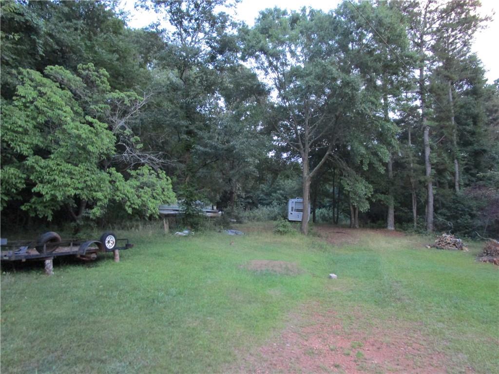 4894 Poplar Springs Road Gainesville, GA 30507 - Photo 1 of 1 a backyard of a house with lots of green space and fountain