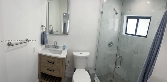 910 Southwest 8th Avenue, Unit B Miami, FL 33130 - Photo 5 of 7 a bathroom with a toilet a sink and mirror