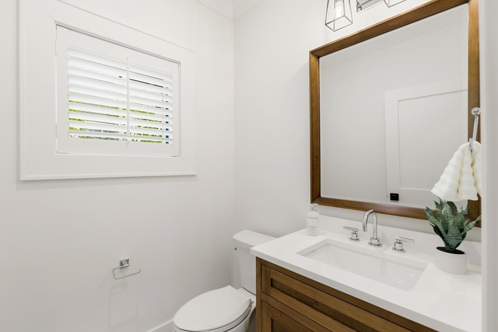 1124 Chestnut Street Newton, MA 02464 - Photo 15 of 41 a bathroom with a sink a toilet and mirror