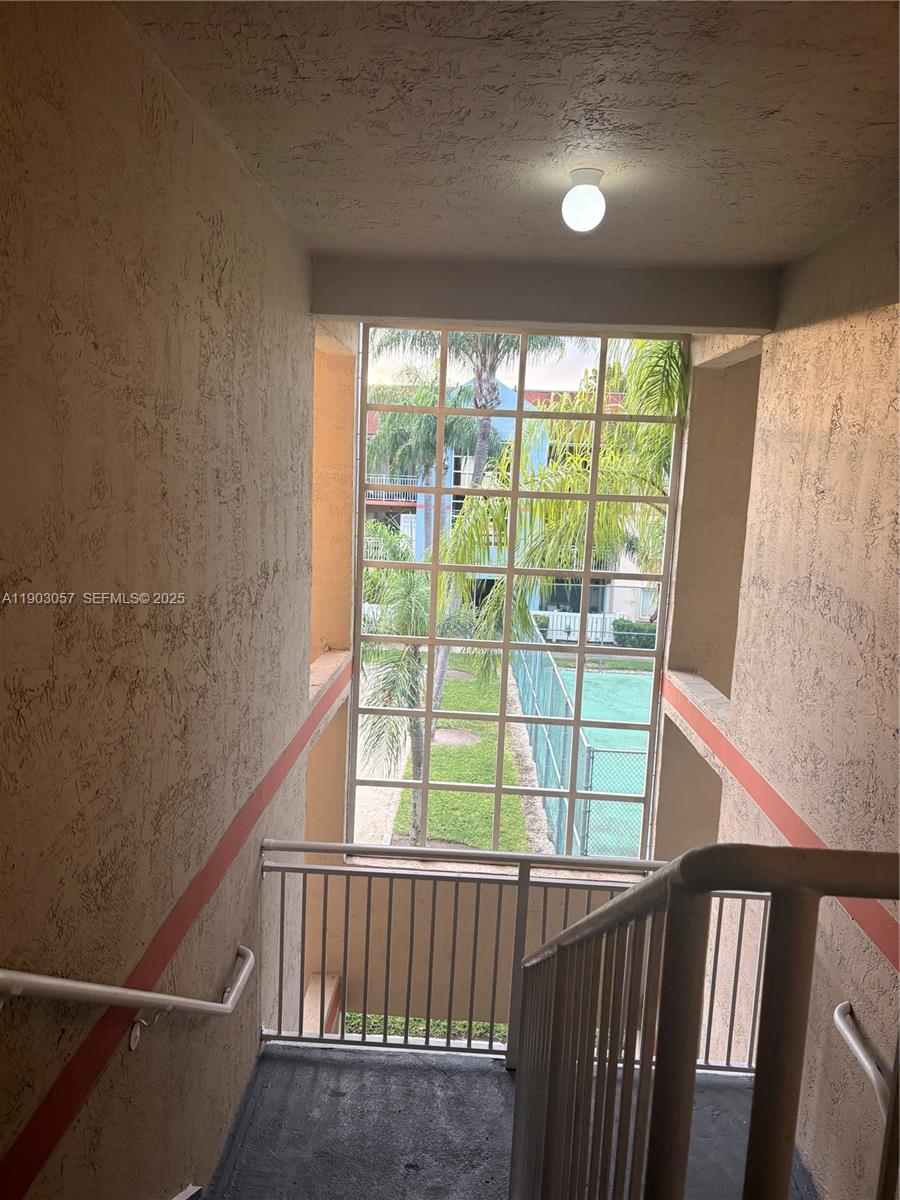 18850 Northwest 57th Avenue, Unit 306 Hialeah, FL 33015 - Photo 13 of 19 a view of entryway with a window and an outdoor space