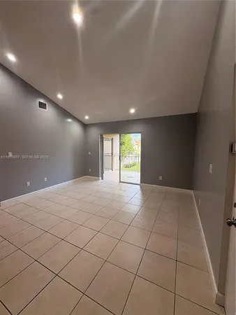 an empty room with windows and gate