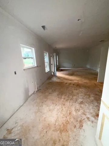 a view of empty room with floor to ceiling windows