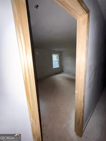a view of a hallway with wooden floor and a hallway