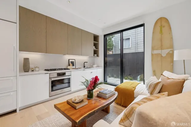 a kitchen with granite countertop a sink cabinets and stainless steel appliances