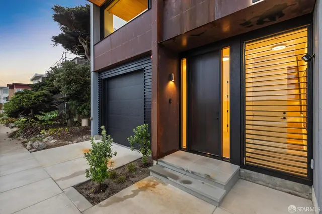 a dining room with furniture a large window and a chandelier