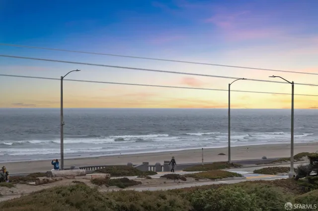 a balcony with furniture and a view of lake