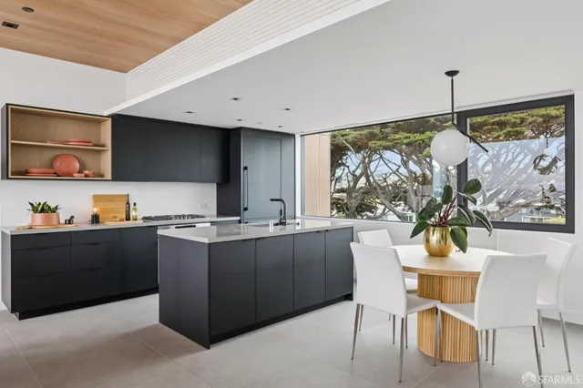 a kitchen with a sink a stove and cabinets