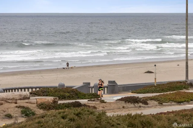 a bedroom with a bed and glass window