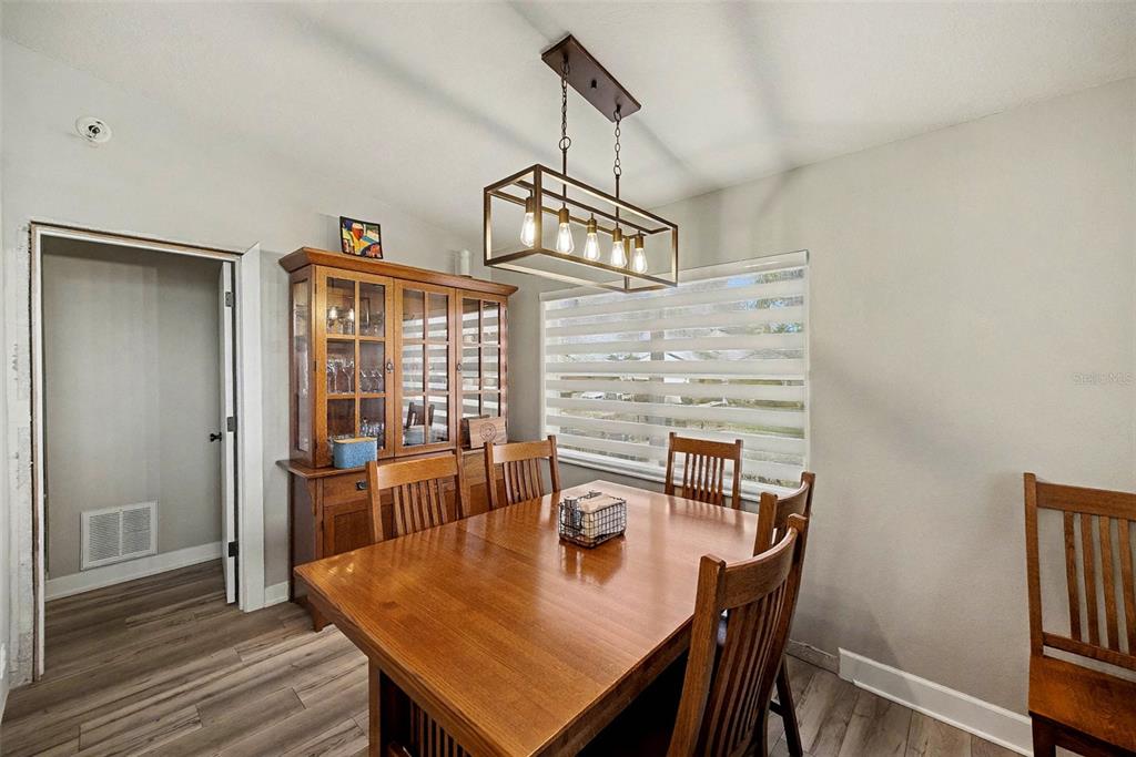 13749 Meade Court Hudson, FL 34667 - Photo 12 of 33 a view of a dining room with furniture wooden floor and chandelier