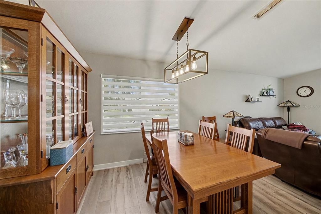 13749 Meade Court Hudson, FL 34667 - Photo 18 of 33 a view of a dining room with furniture window and wooden floor