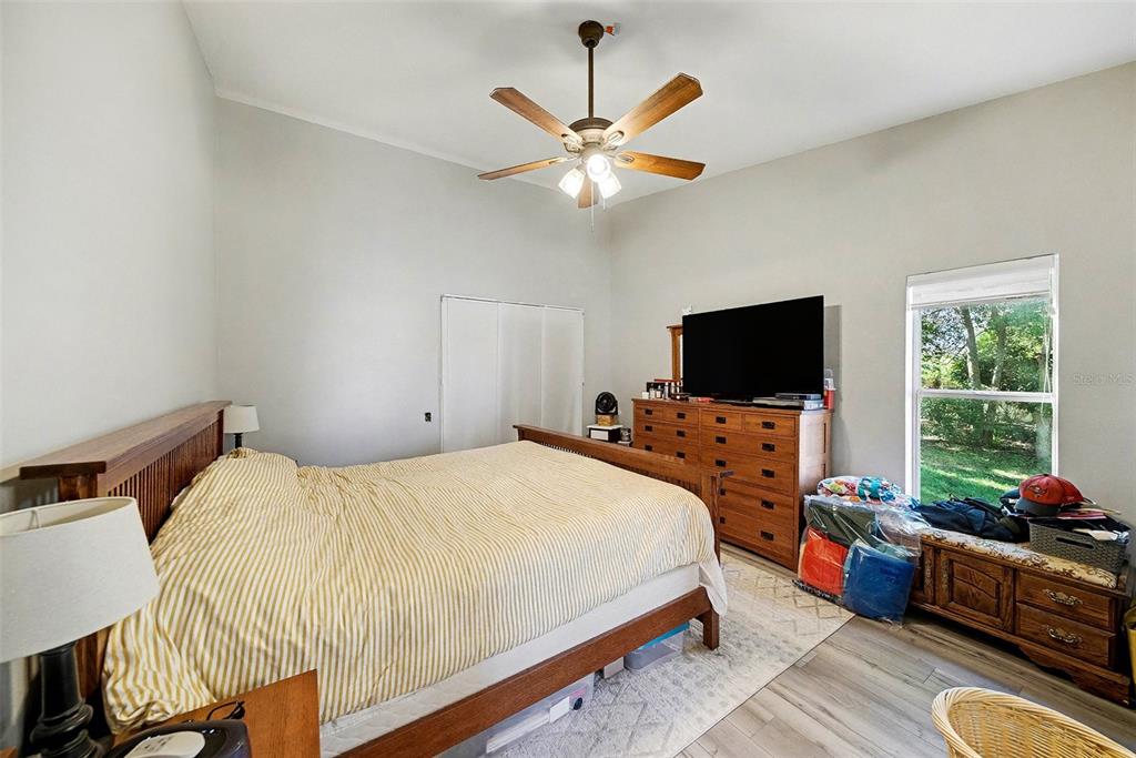 13749 Meade Court Hudson, FL 34667 - Photo 20 of 33 a bedroom with a bed furniture and a flat screen tv