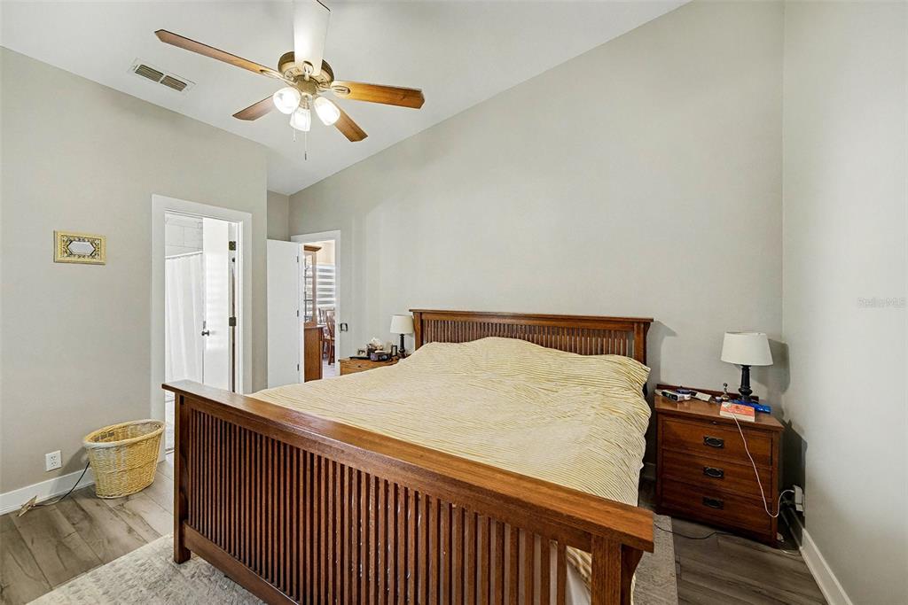 13749 Meade Court Hudson, FL 34667 - Photo 21 of 33 a bedroom with a bed and a chandelier