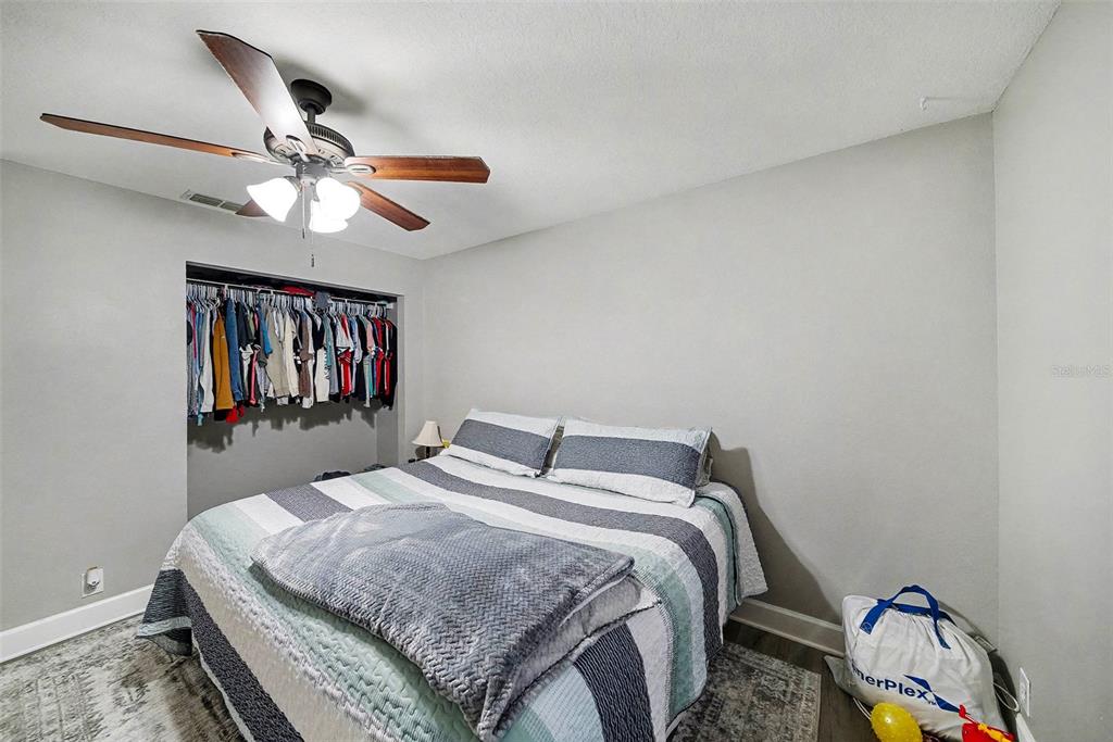 13749 Meade Court Hudson, FL 34667 - Photo 23 of 33 a bedroom with a bed and a chandelier